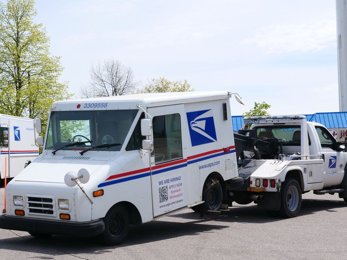 Tow truck towing a delivery van